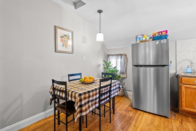 dining space with light hardwood / wood-style floors