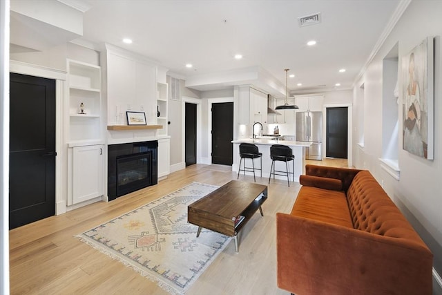 40 Mount Vernon St Unit 2, Boston, MA 02129 - living area with crown molding, light wood-type flooring, recessed lighting, and a large fireplace