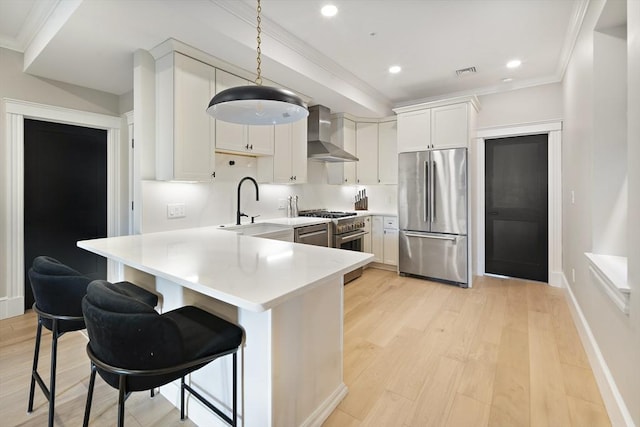 40 Mount Vernon St Unit 2, Boston, MA 02129 - kitchen with stainless steel appliances, wall chimney range hood, crown molding, light wood finished floors, and light countertops