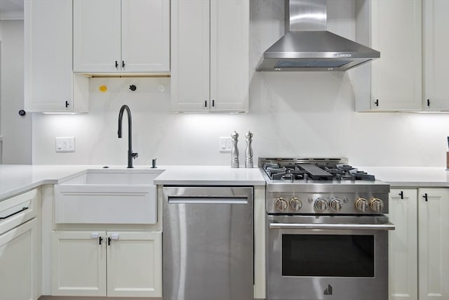 40 Mount Vernon St Unit 2, Boston, MA 02129 - kitchen featuring wall chimney range hood, stainless steel appliances, white cabinets, and light countertops