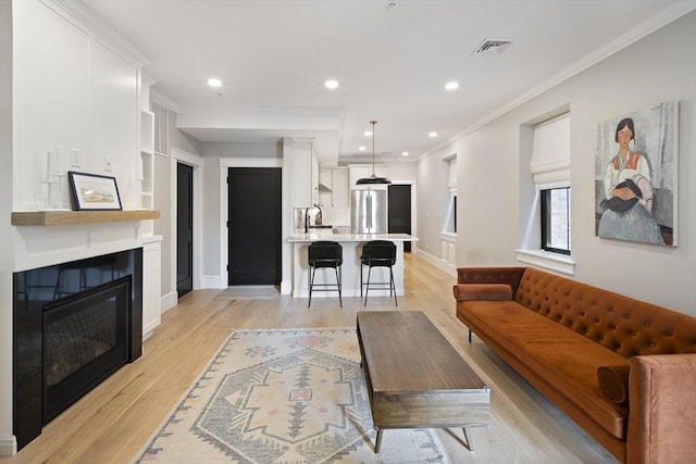 40 Mount Vernon St Unit 2, Boston, MA 02129 - living area with crown molding, light wood-style flooring, a large fireplace, and recessed lighting