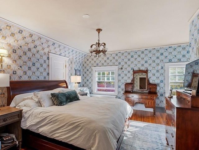 23 Newmarch St, Ipswich, MA 01938 - bedroom featuring a chandelier, wallpapered walls, multiple windows, wood finished floors, and ornamental molding