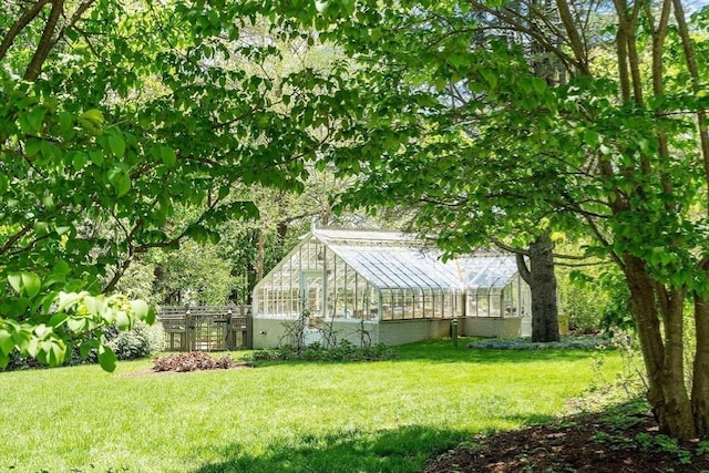 23 Newmarch St, Ipswich, MA 01938 - view of green lawn with a greenhouse and an outdoor structure