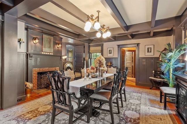 23 Newmarch St, Ipswich, MA 01938 - dining area featuring a brick fireplace, light wood-type flooring, coffered ceiling, a chandelier, and beam ceiling