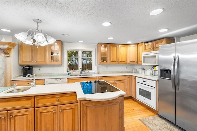 11 Bayside Dr, Wales, MA 01081 - kitchen featuring white appliances, a sink, a textured ceiling, light countertops, and light wood finished floors