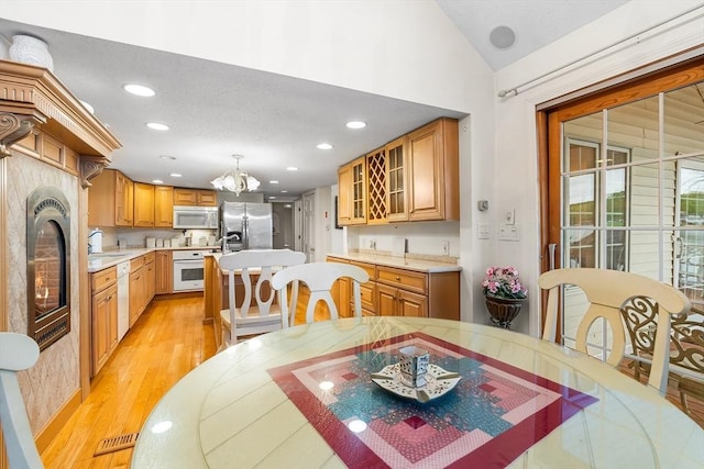 11 Bayside Dr, Wales, MA 01081 - dining area featuring light wood finished floors, vaulted ceiling, a chandelier, and recessed lighting