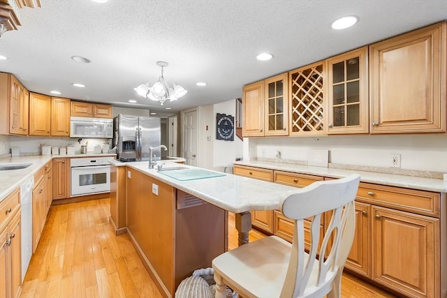11 Bayside Dr, Wales, MA 01081 - kitchen featuring white appliances, recessed lighting, a kitchen island with sink, light countertops, and a chandelier