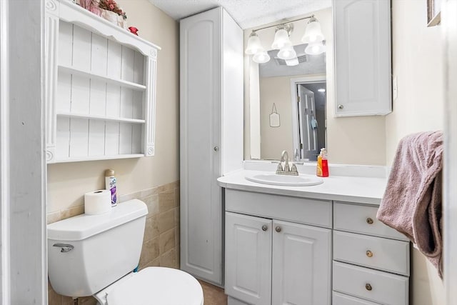 11 Bayside Dr, Wales, MA 01081 - bathroom featuring vanity, toilet, and a textured ceiling