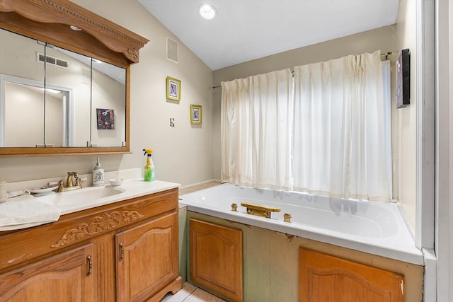 11 Bayside Dr, Wales, MA 01081 - bathroom featuring vanity, a bath, and lofted ceiling