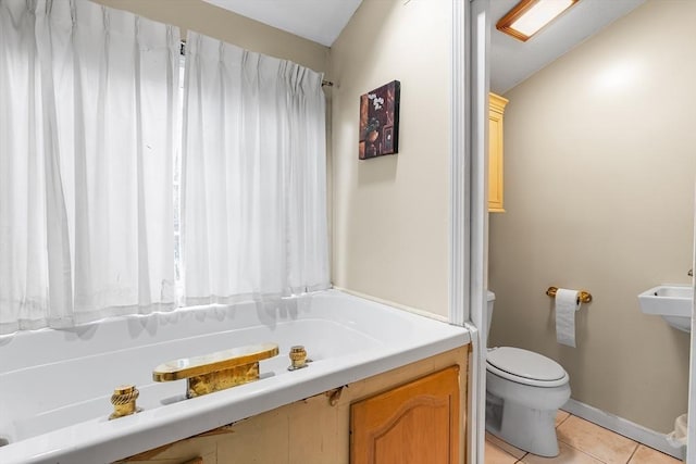 11 Bayside Dr, Wales, MA 01081 - bathroom with toilet, tile patterned floors, a tub to relax in, and baseboards