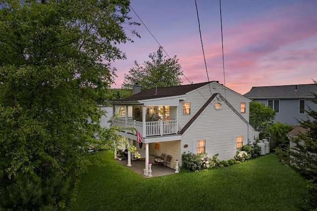 11 Bayside Dr, Wales, MA 01081 - back of property featuring a balcony, a yard, a patio area, and a chimney