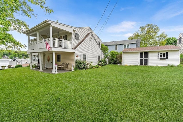 11 Bayside Dr, Wales, MA 01081 - rear view of house with a balcony, a lawn, and a patio area