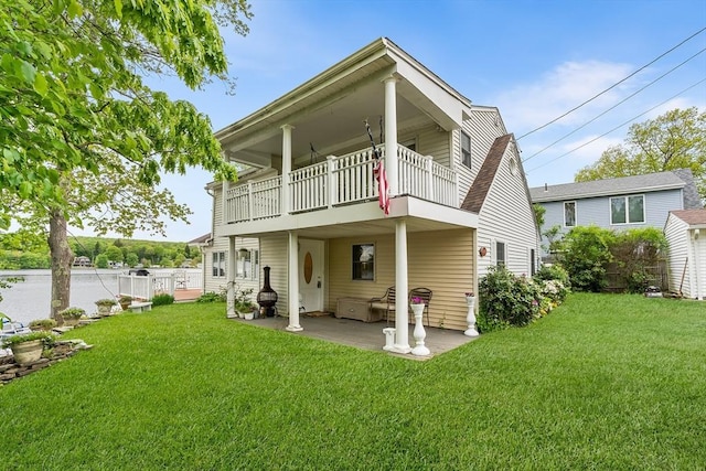11 Bayside Dr, Wales, MA 01081 - back of property with a balcony, a patio, and a lawn