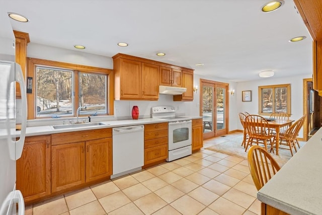 kitchen featuring sink, white appliances, and light tile patterned floors