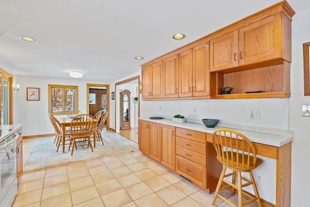 kitchen with built in desk and light tile patterned floors