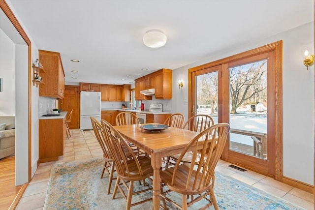 tiled dining area featuring sink