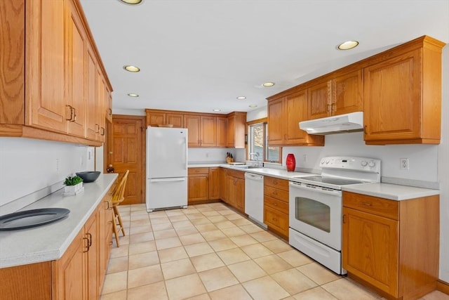 kitchen featuring light tile patterned flooring, sink, and white appliances