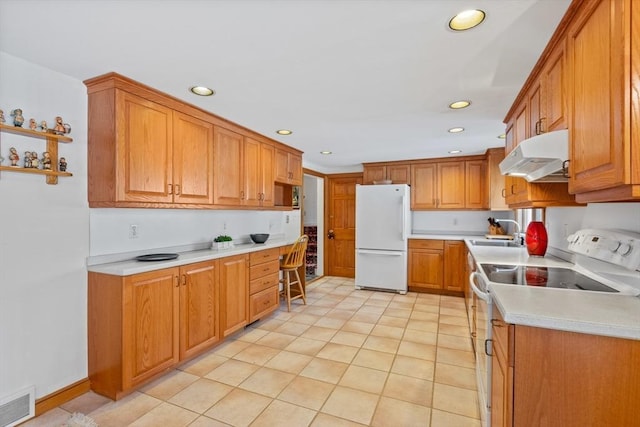 kitchen with sink, white appliances, and light tile patterned flooring