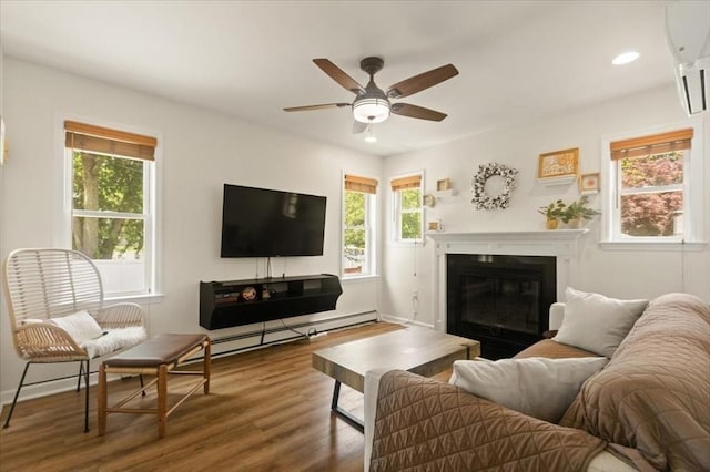14 Carlson Cv, Weymouth, MA 02189 - living area featuring a baseboard heating unit, wood finished floors, ceiling fan, a wall mounted air conditioner, and recessed lighting