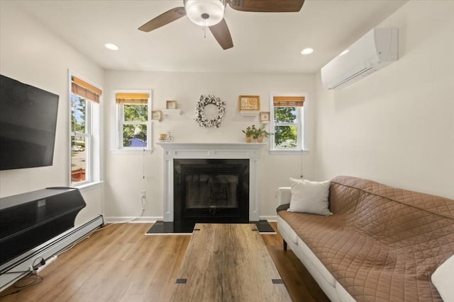 14 Carlson Cv, Weymouth, MA 02189 - living area with a wall unit AC, a baseboard radiator, a glass covered fireplace, plenty of natural light, and recessed lighting