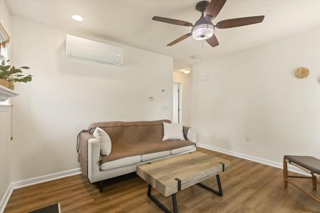 14 Carlson Cv, Weymouth, MA 02189 - living area featuring a wall unit AC, wood finished floors, a ceiling fan, and baseboards
