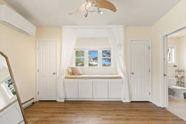 14 Carlson Cv, Weymouth, MA 02189 - unfurnished bedroom with a wall unit AC, light wood-style flooring, a baseboard heating unit, and ceiling fan