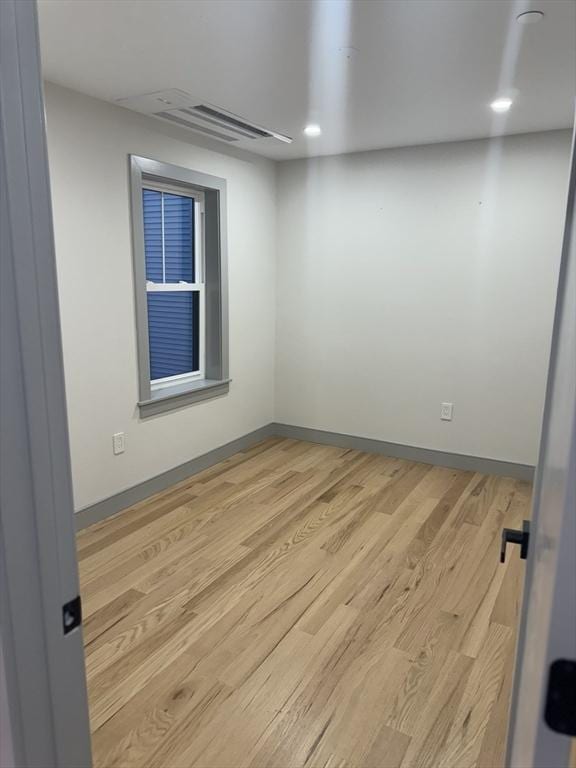 spare room with light wood-type flooring