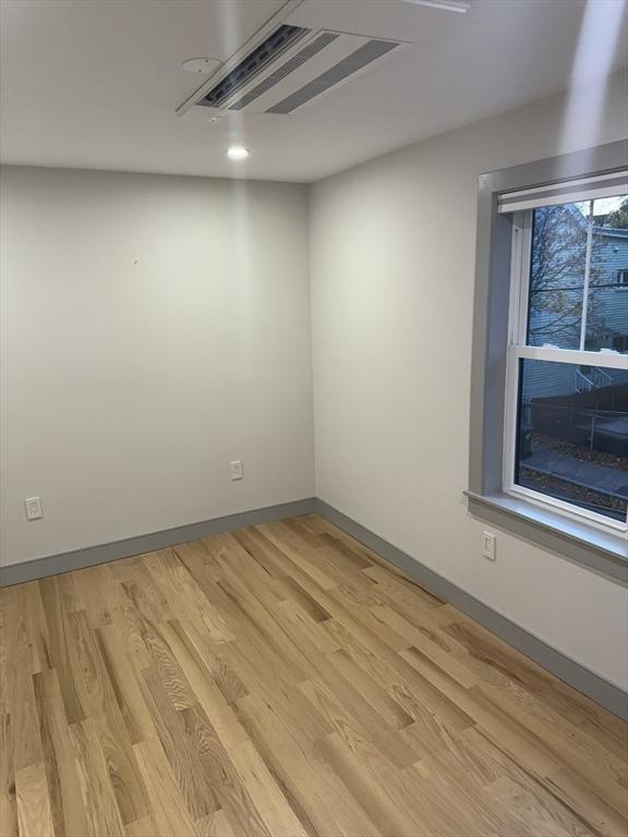 unfurnished room with light hardwood / wood-style floors