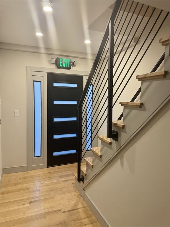 foyer with crown molding and hardwood / wood-style floors