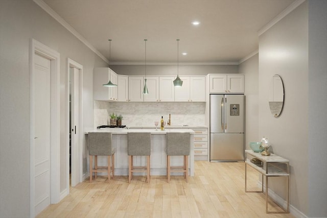 kitchen featuring white cabinetry, a peninsula, stainless steel fridge, decorative backsplash, and light wood-type flooring