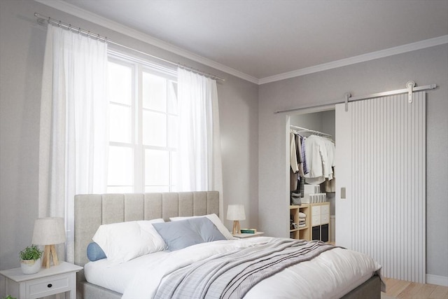 bedroom featuring baseboards, ornamental molding, light wood-style flooring, and a spacious closet