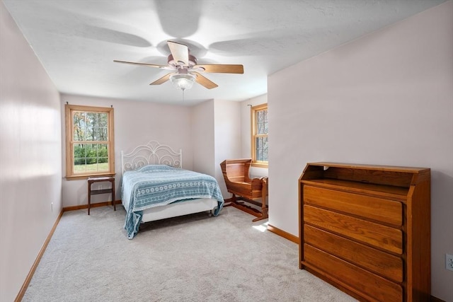 bedroom with carpet flooring, a ceiling fan, and baseboards