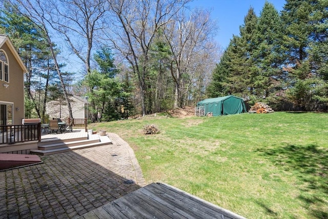view of yard featuring a deck and a patio
