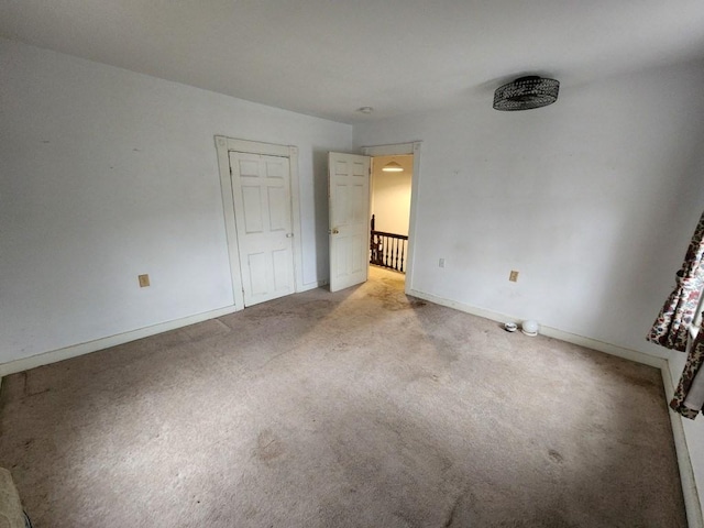 unfurnished bedroom with light colored carpet