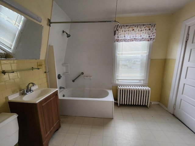 full bathroom with decorative backsplash, vanity, shower / bathing tub combination, radiator heating unit, and toilet