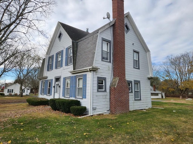 view of property exterior with a yard