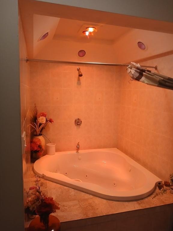 bathroom with a relaxing tiled tub