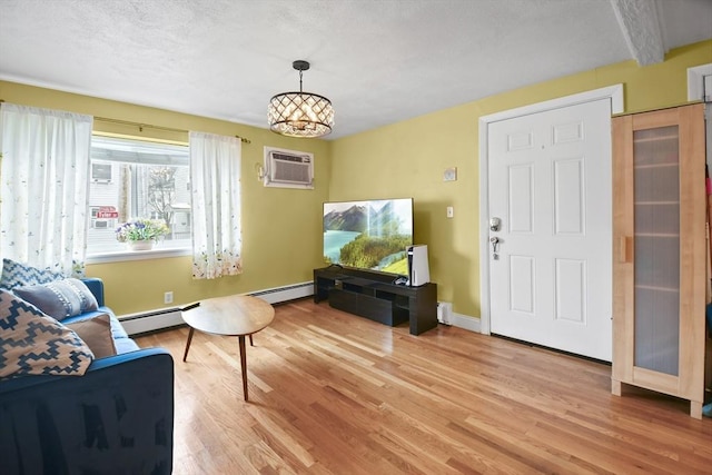 living room with light wood-type flooring, baseboard heating, a wall mounted AC, beamed ceiling, and a notable chandelier