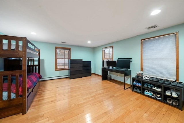 bedroom featuring a baseboard radiator and light hardwood / wood-style floors