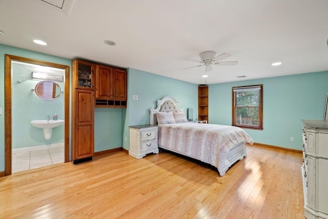 bedroom with ceiling fan, light hardwood / wood-style floors, and ensuite bathroom