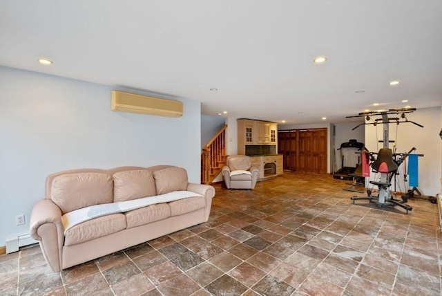 living room with an AC wall unit and baseboard heating