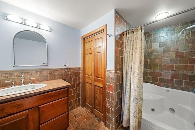 bathroom featuring tile patterned flooring, vanity, shower / bathtub combination with curtain, and tile walls