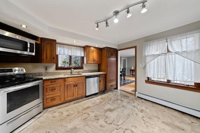 kitchen featuring sink, a baseboard radiator, and appliances with stainless steel finishes