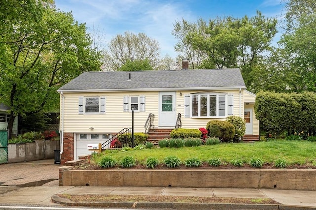 view of front of home featuring entry steps, a garage, a chimney, driveway, and roof with shingles