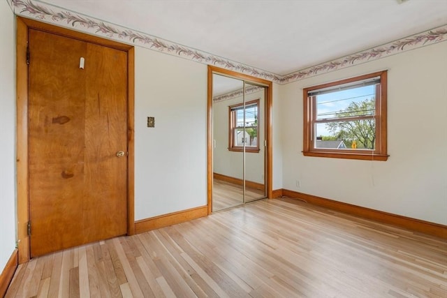empty room with baseboards and light wood-style flooring