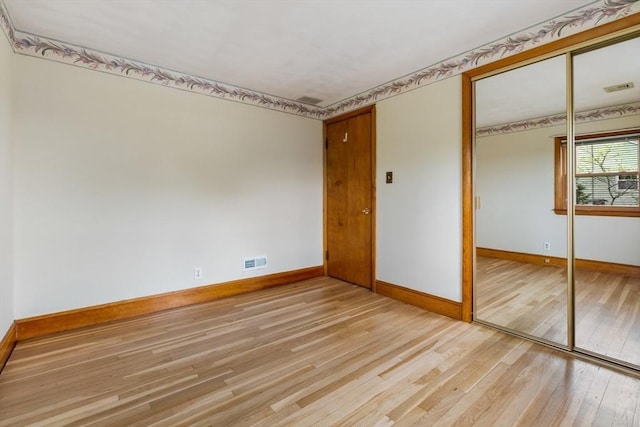 empty room with baseboards and light wood-style floors