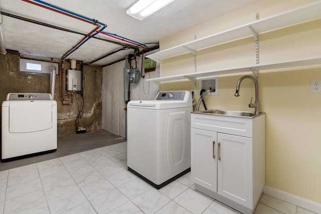 laundry room with washer and dryer and water heater