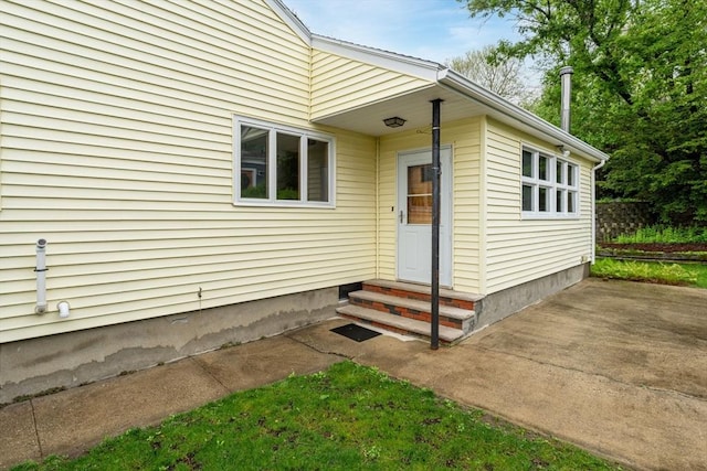 view of exterior entry featuring a patio