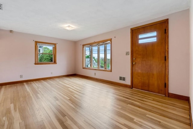 foyer featuring light wood-type flooring and baseboards