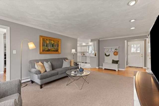 living area with recessed lighting, a baseboard radiator, baseboards, and ornamental molding